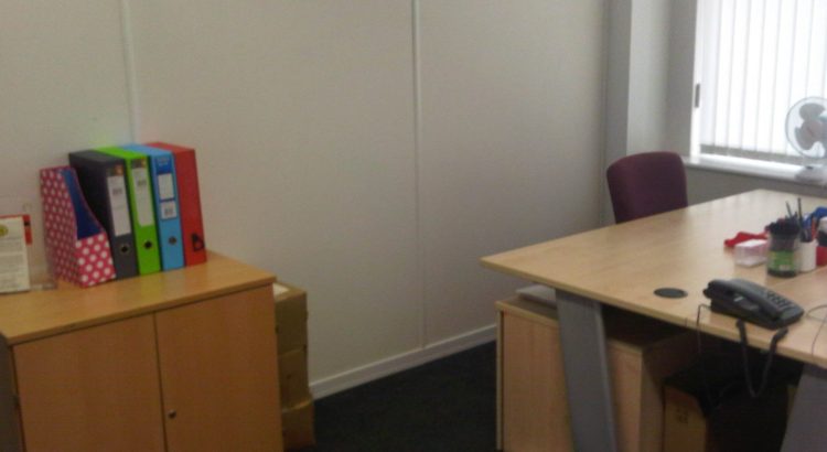 A picture taken in 2019 of the former BuDS office, showing a desk, cupboard and box files