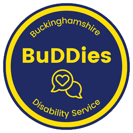 The blue and yellow BuDDies logo. It is a circular logo with the word 'BuDDies' in the centre above an image of two speech bubbles, one of which has a heart in it.